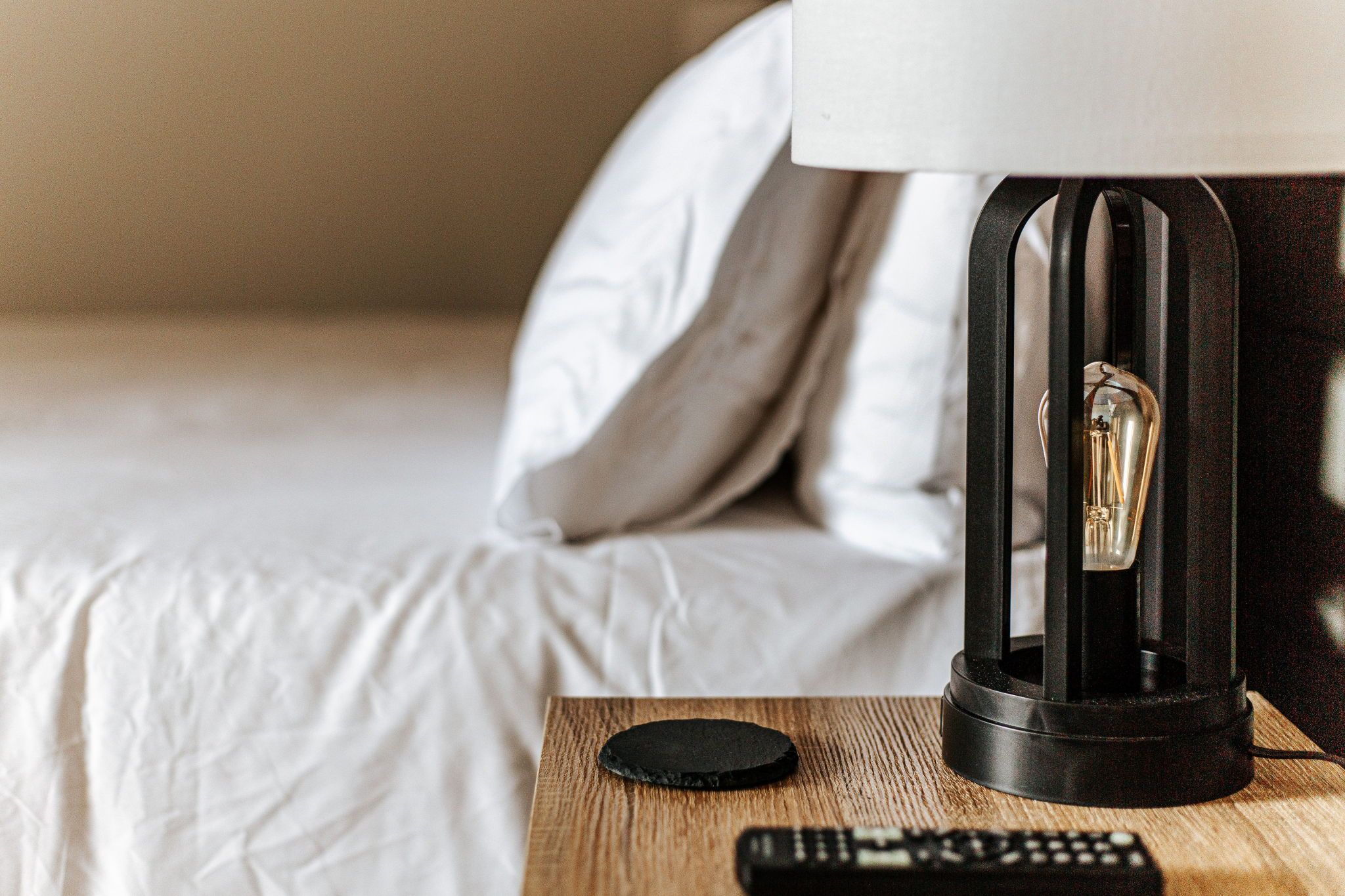 image Settle in with a cozy bedside ambiance, your relaxation just a lamp's glow away.