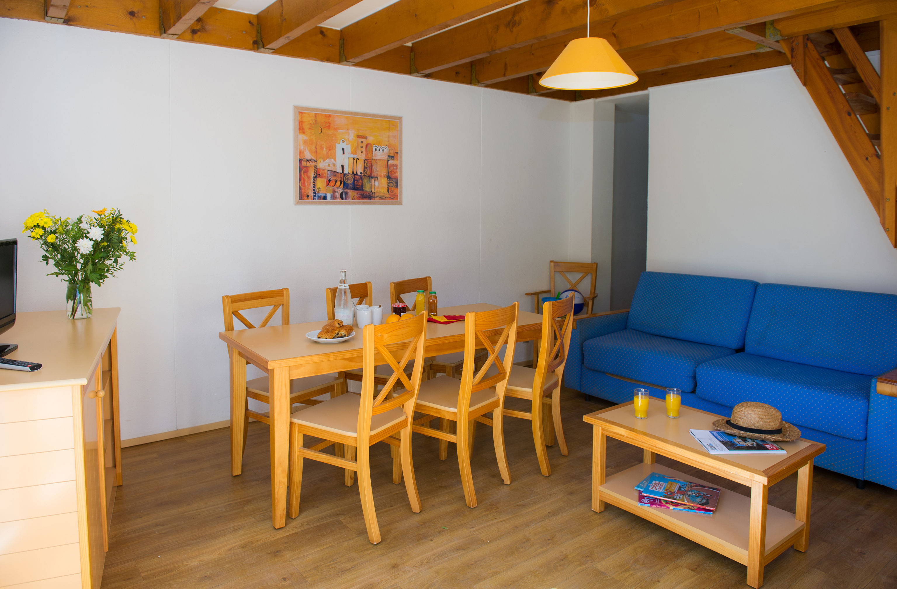 image A comfortable living space with dining area and sofa, ideal for unwinding after a day at the beach.