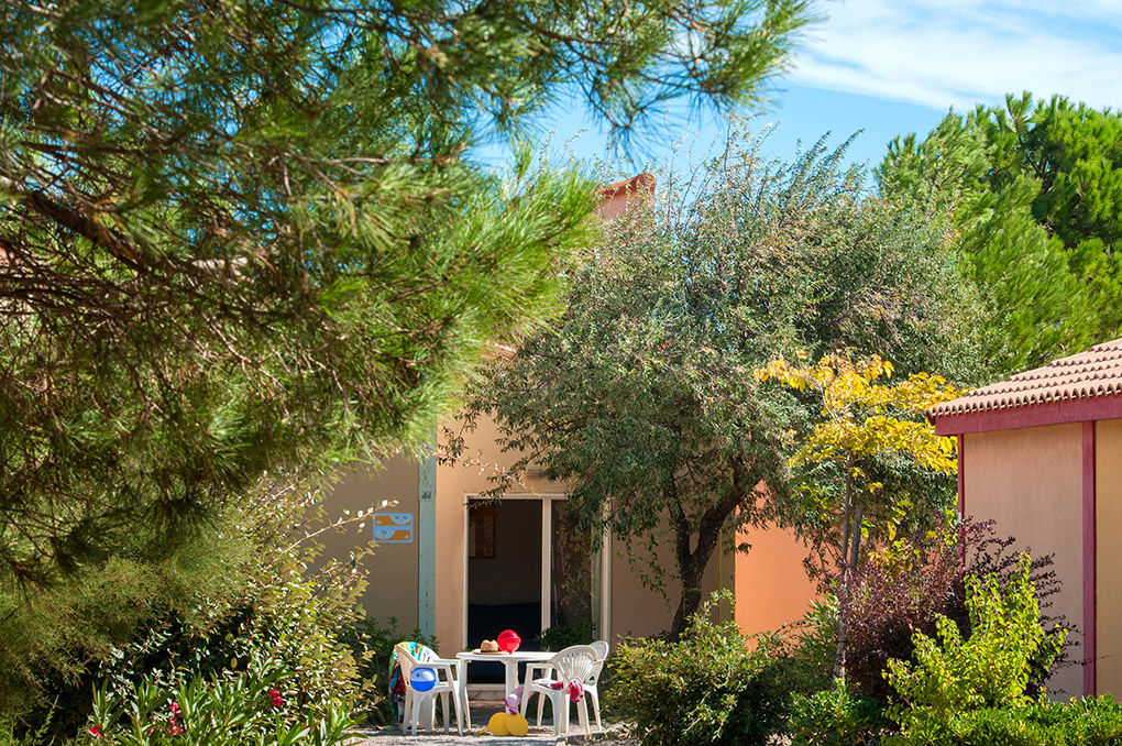 image A generous private terrace nestled among pine trees and Mediterranean garden, ideal for alfresco dining.