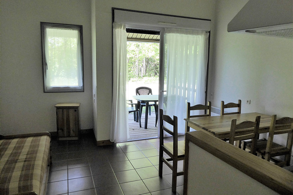 image Open-plan living and dining area with natural light and access to the terrace.