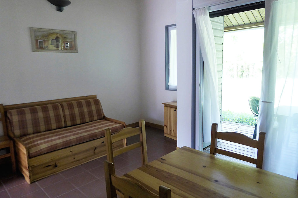 image Sofa bed in the living room, with the terrace door open to the garden.
