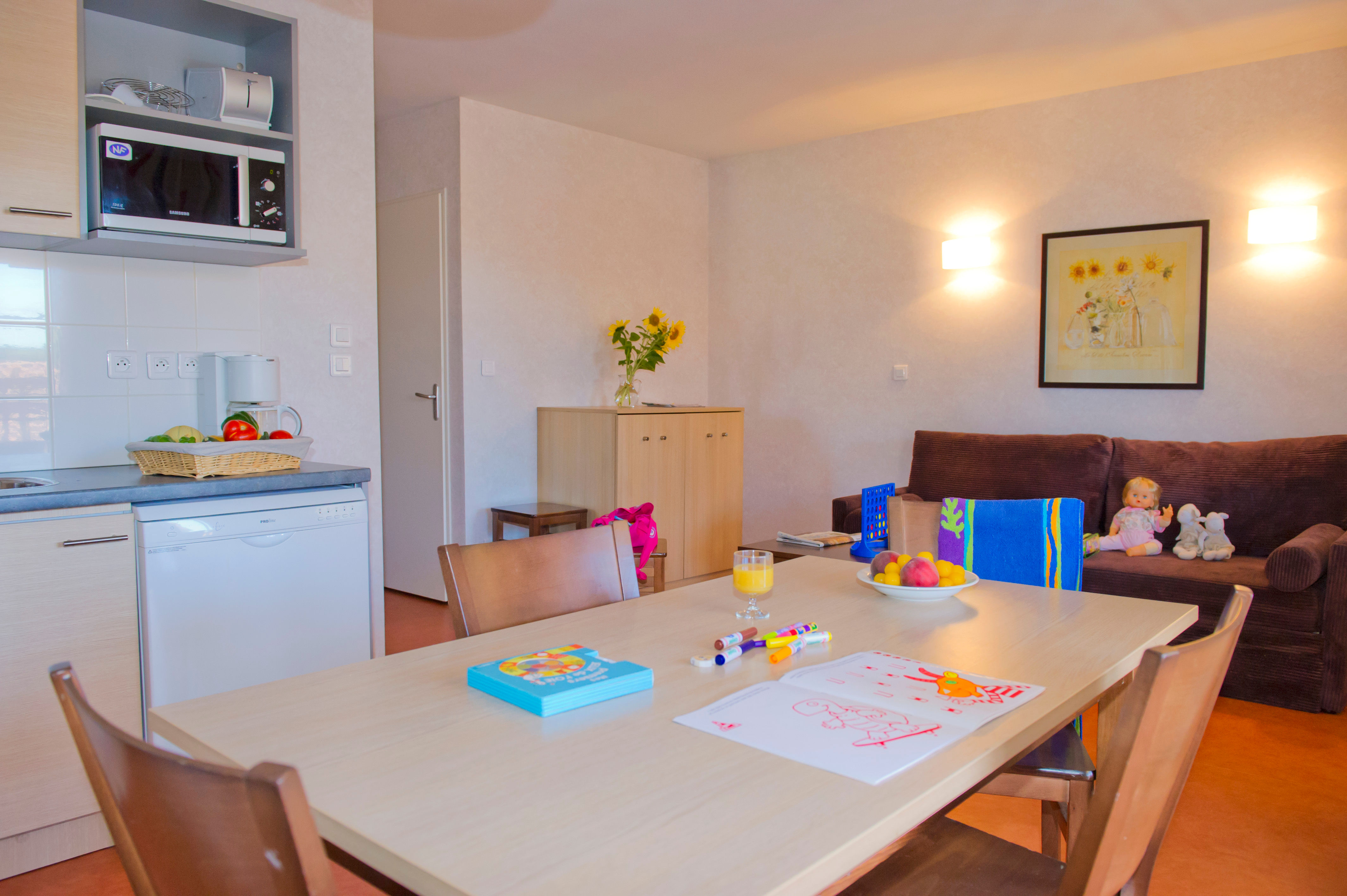 image Living area with a sofa bed, TV unit, and dining table — the 40 m² cabin apartment gives the family room to spread out.