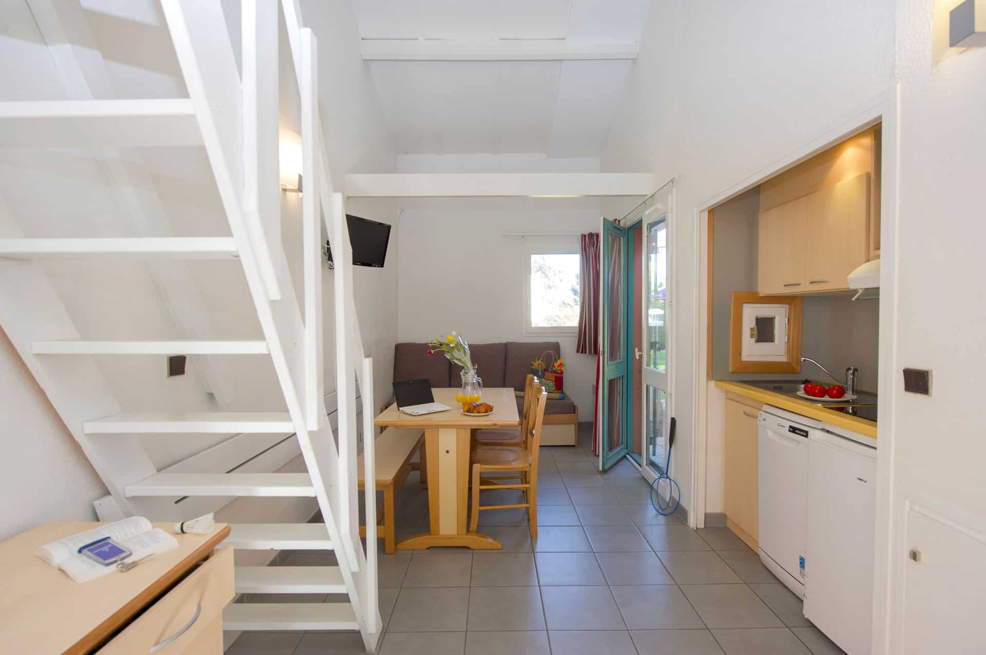 image The light-filled living area with kitchenette and terrace access — a comfortable base for a family holiday.