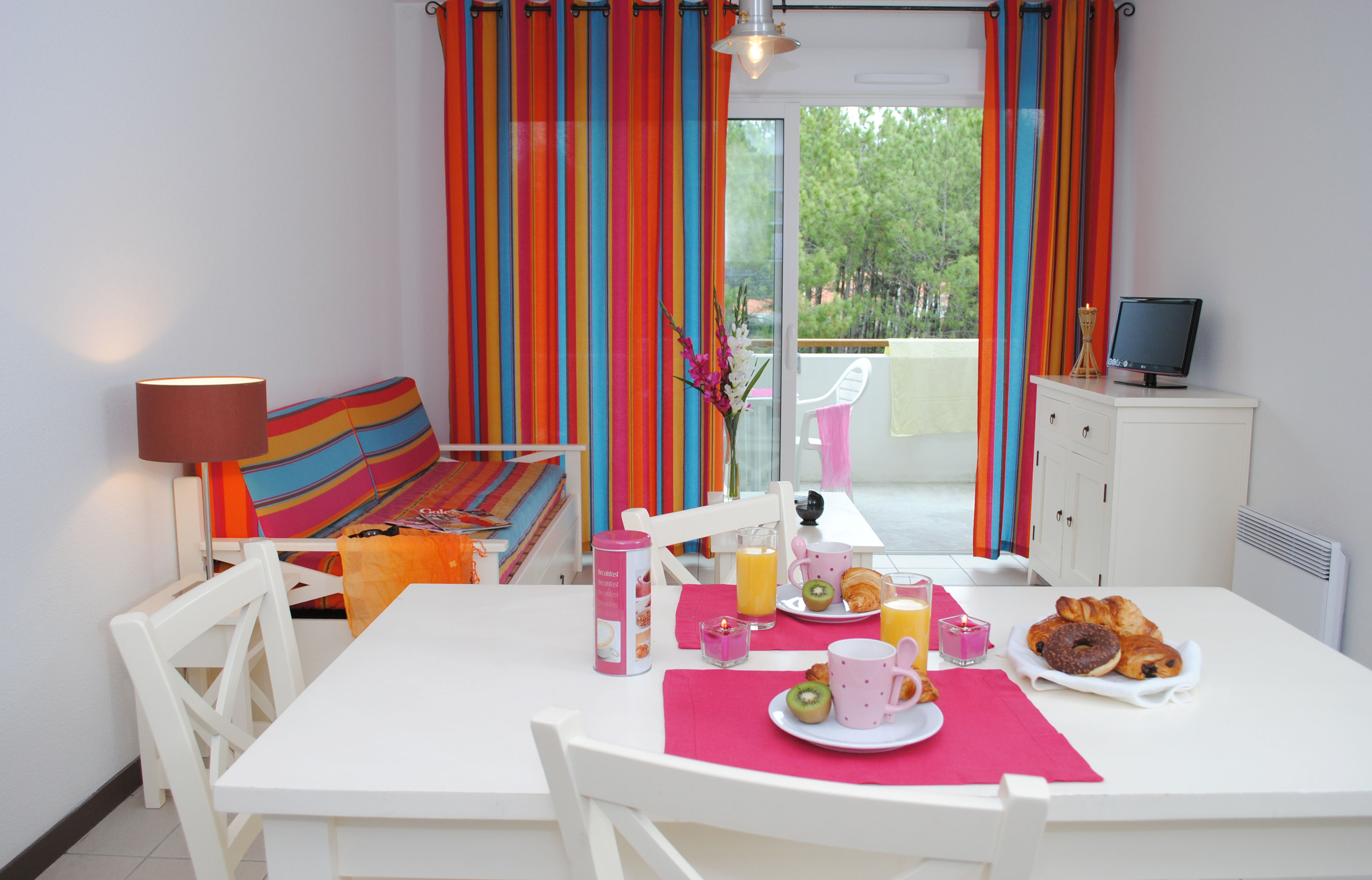 image The open-plan layout keeps the whole group together, with a dining table, kitchenette, and easy access to the terrace.