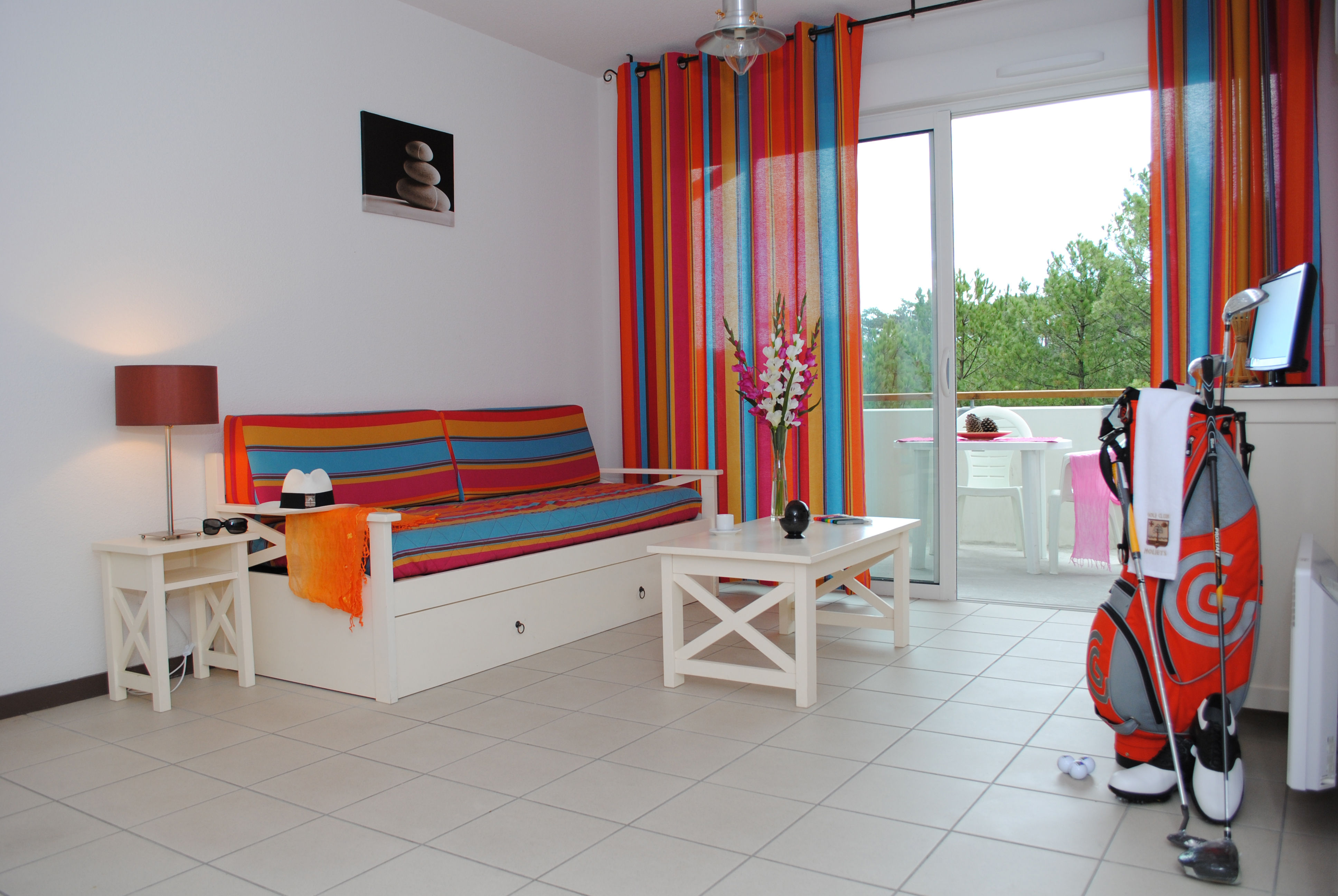 image The colourful living area provides a welcoming space to relax after a day on the Atlantic surf beach, just 600 metres from the residence.