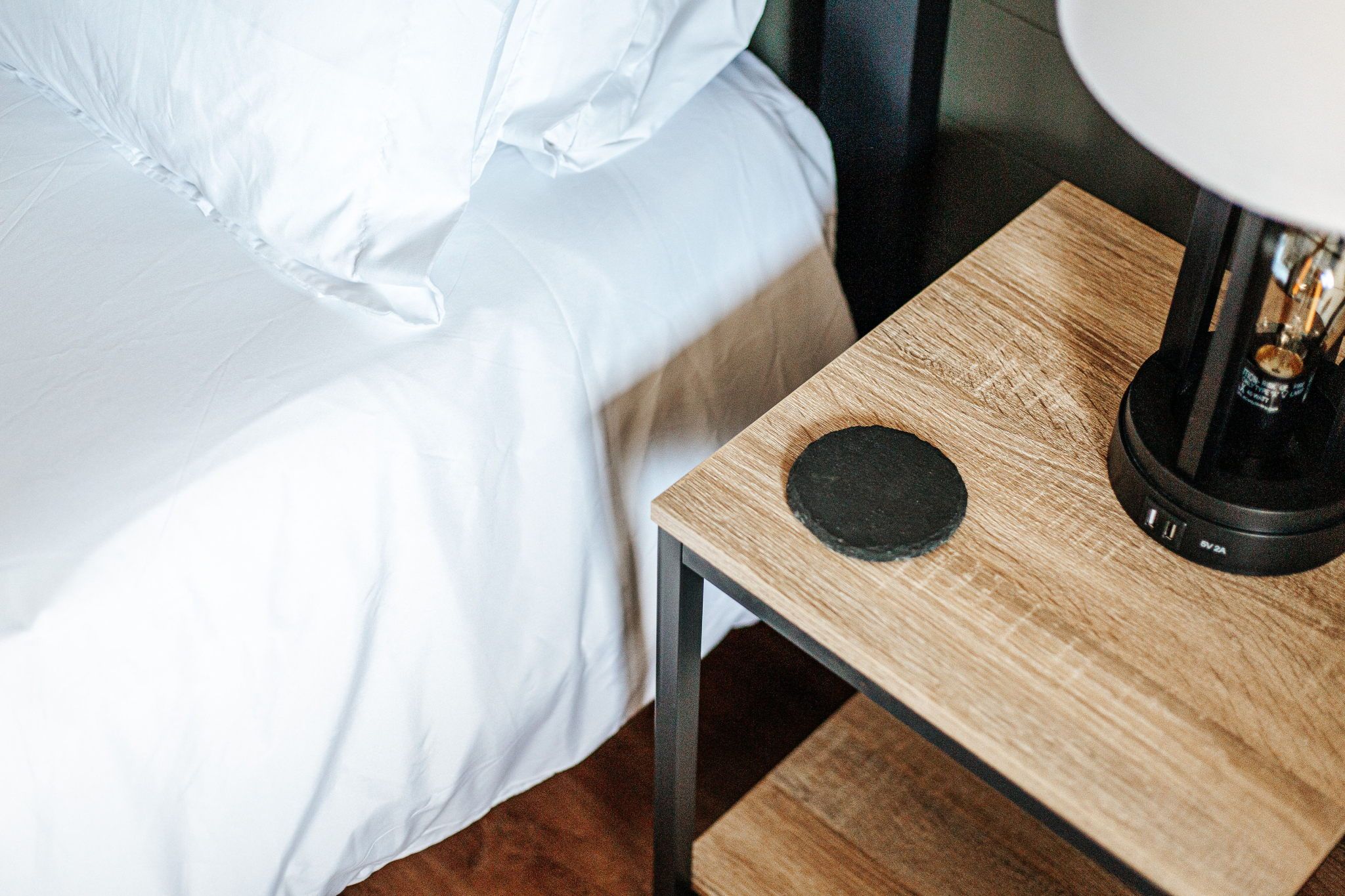 image A chic tabletop ready for your favorite beverage, with a sleek lamp adding a touch of elegance.