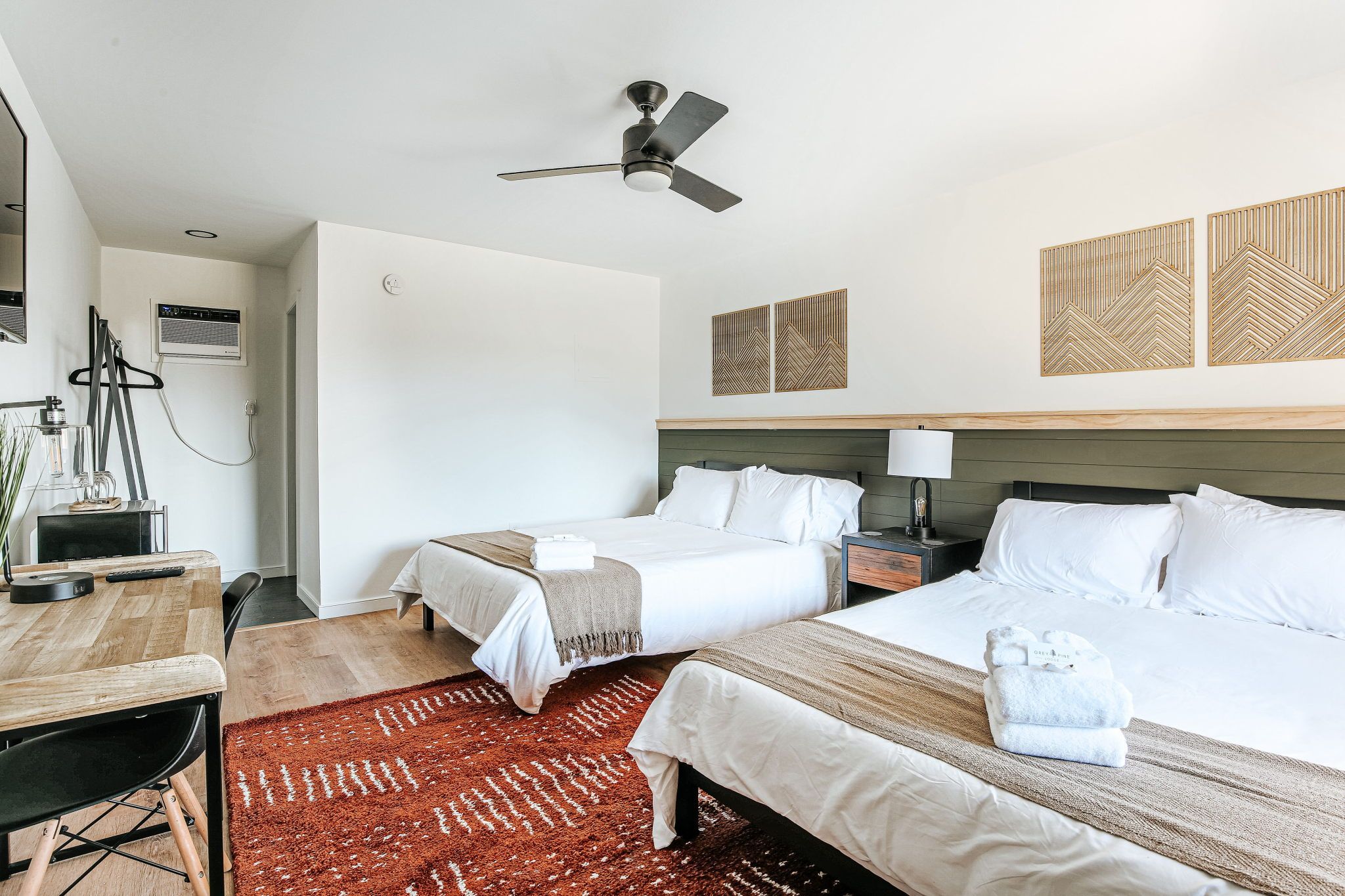 image Relax on soft queen beds, surrounded by warm decor and a cozy ambiance ideal for restful nights.
