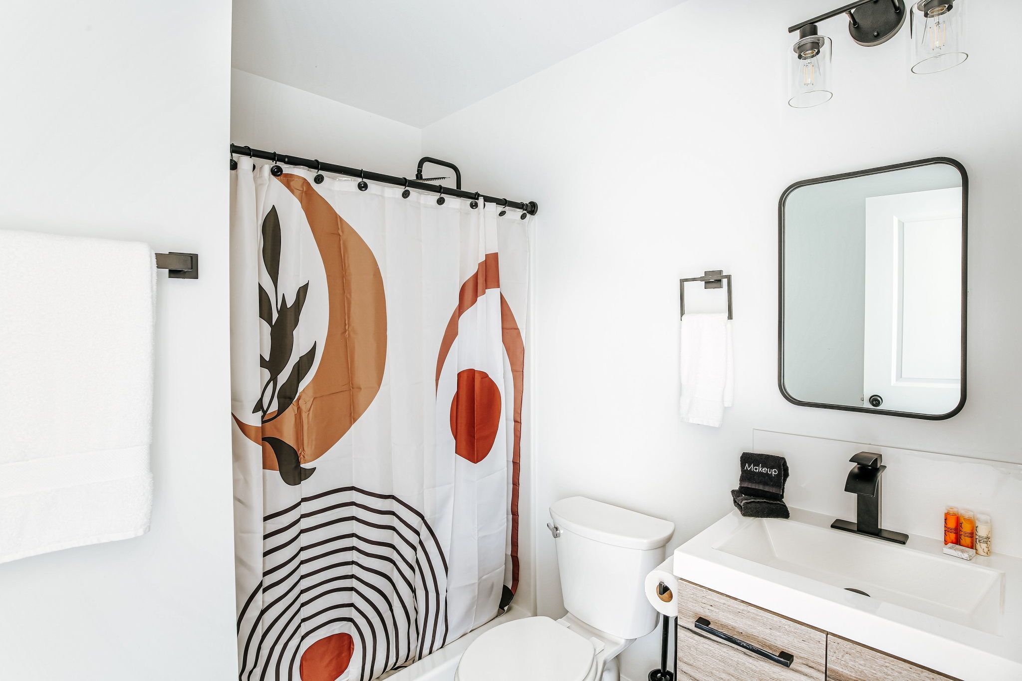 image Fresh and modern, this bathroom features chic decor and essential amenities for your convenience.