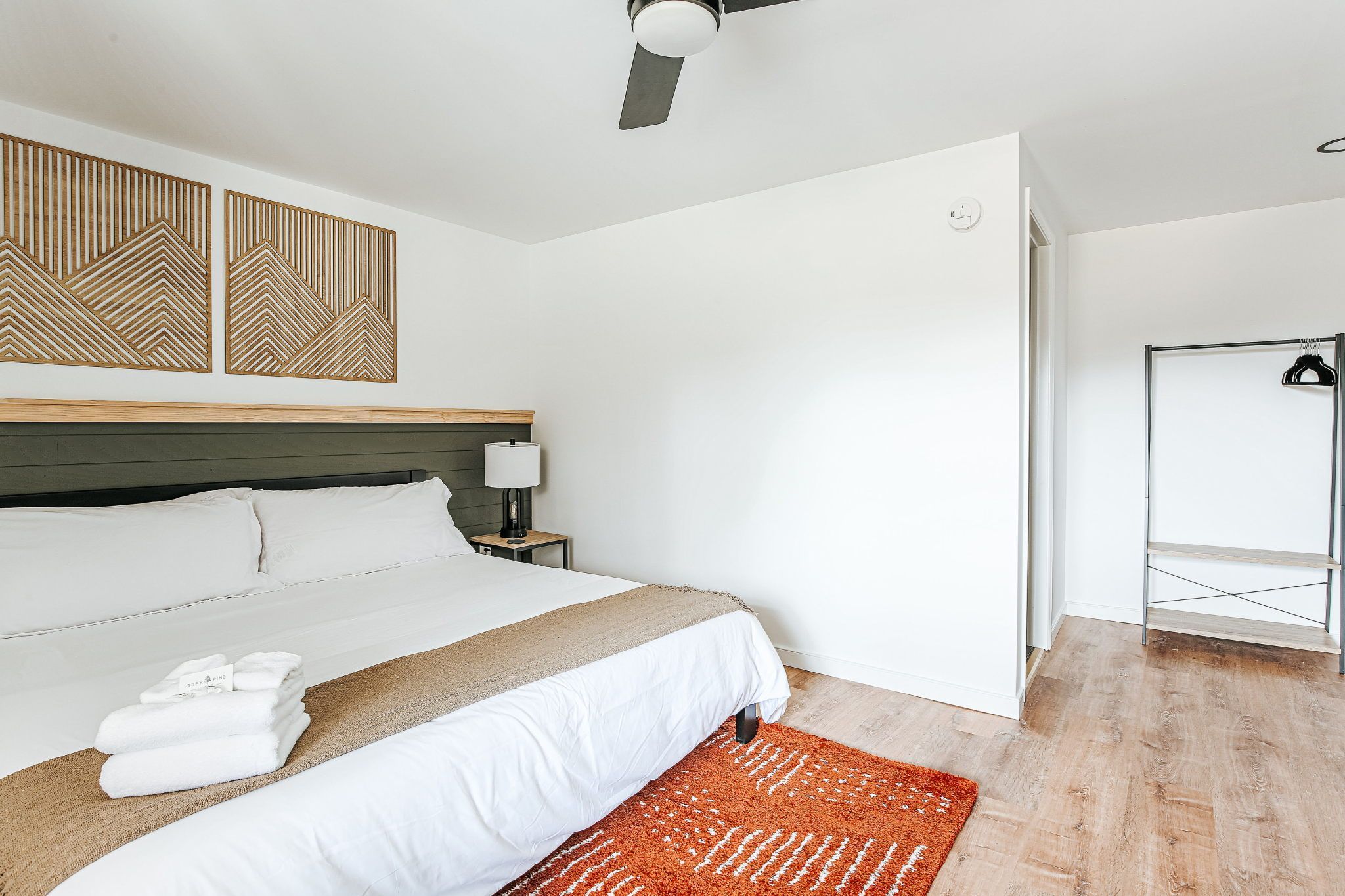 image Cozy up in a spacious sleeping area adorned with chic decor and a soothing color palette.