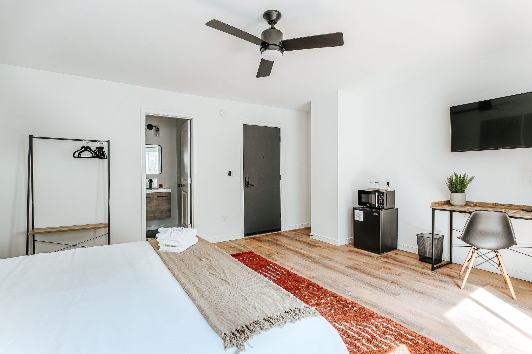 image Relax in a stylish room featuring a plush king bed and a cozy sitting area.