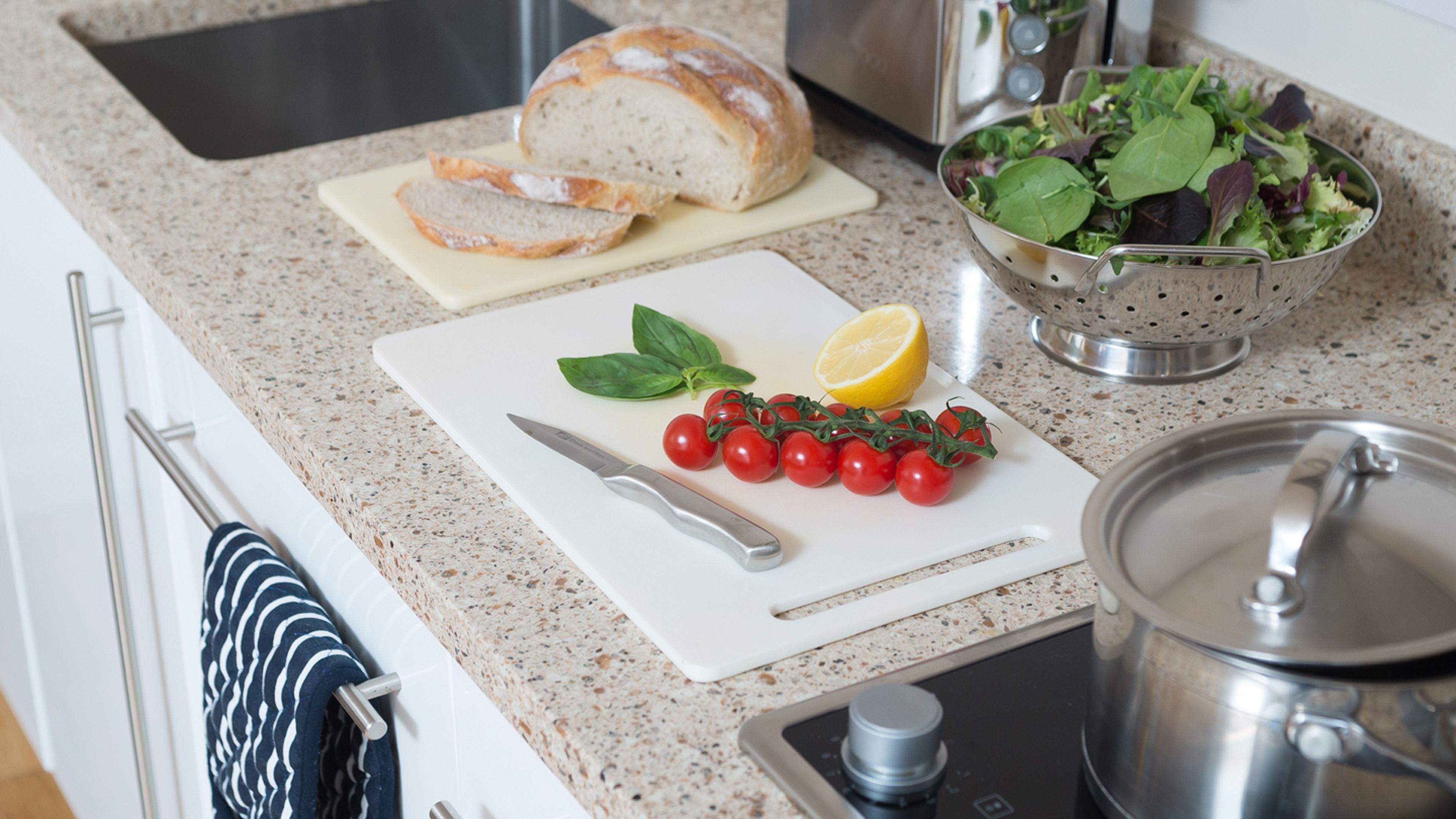 image Kitchenette with cookware, cutting board, and cooking ingredients.
