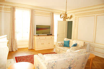 The living area is fully shared across both suites, with comfortable seating and a television for evenings in.