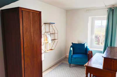 A quiet corner of the estate with a writing desk and armchair — a comfortable spot to plan the next day's vineyard visits.
