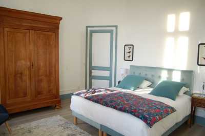 Bright and individually styled, this bedroom reflects the personal touch that comes with a private family estate rental.