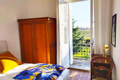 One of four decorated bedrooms, with direct balcony access and views over the vineyards and surrounding countryside.