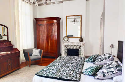 A restful bedroom with views over the estate grounds, part of this exclusively private-hire château in the Côtes de Bourg.
