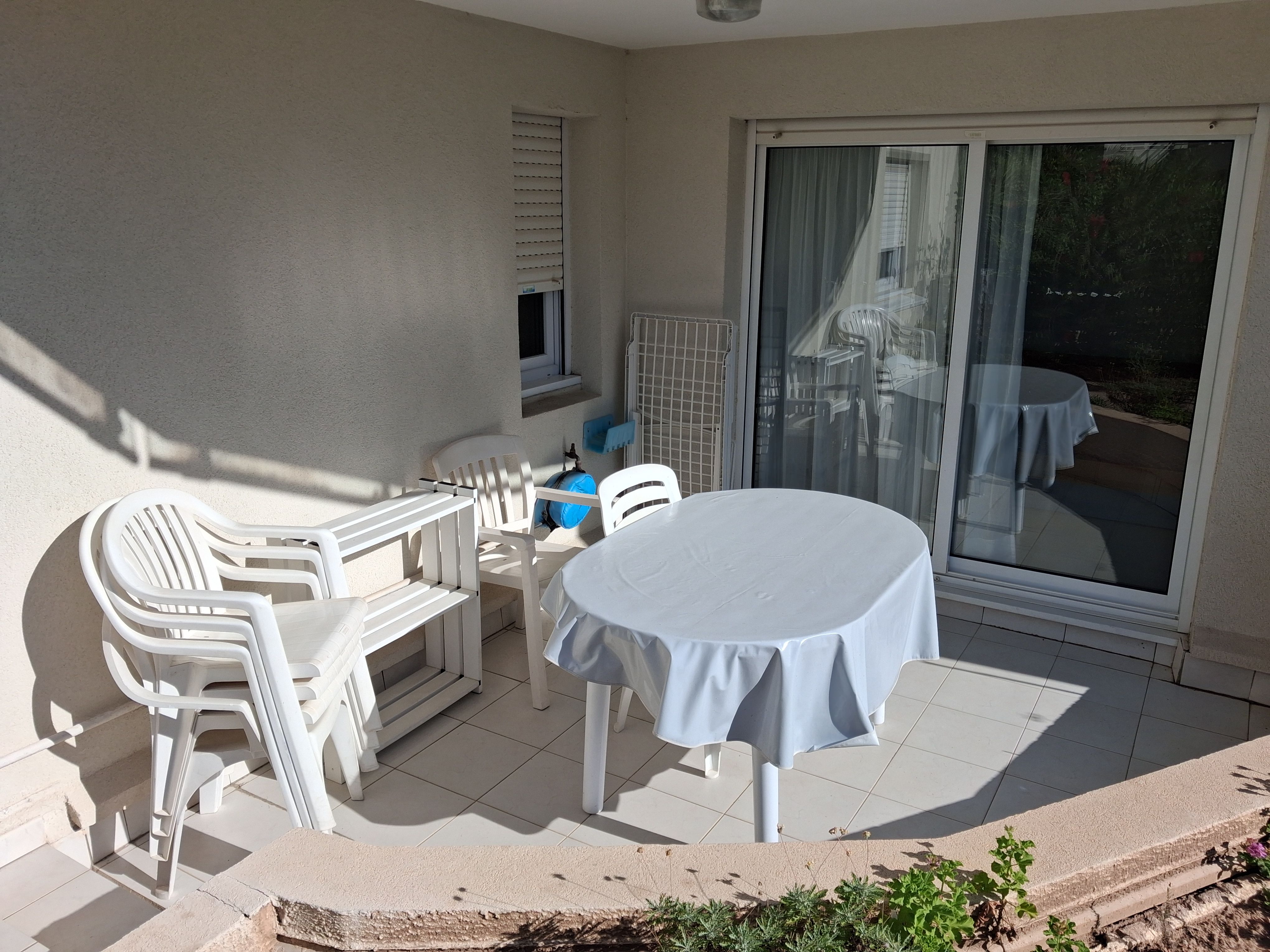 image Morning coffee or an evening glass of rosé — the terrace table seats the whole group with sliding doors to the living room