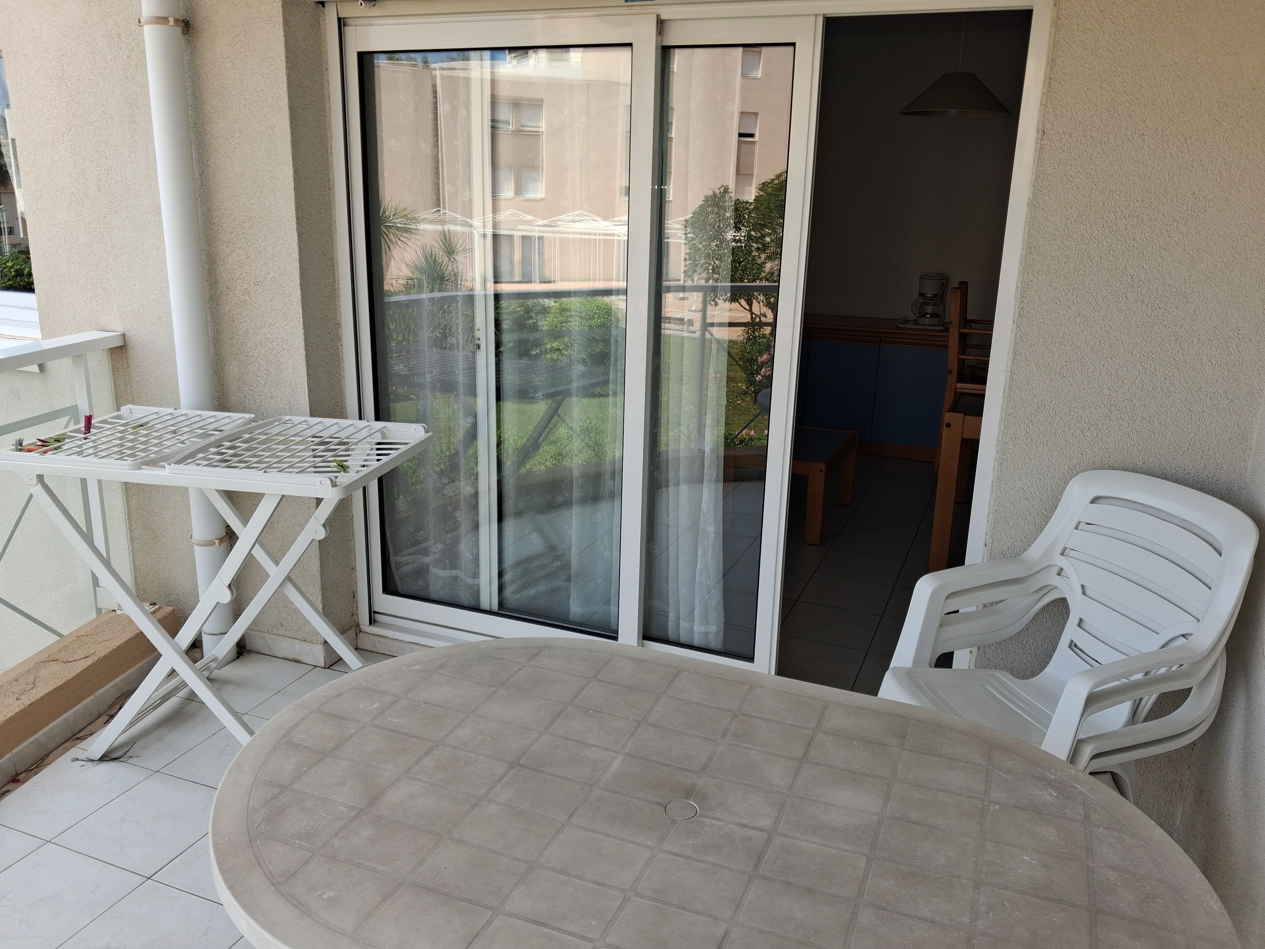 image Step out onto the balcony with a table and chair — the beach is just 200 m away on foot
