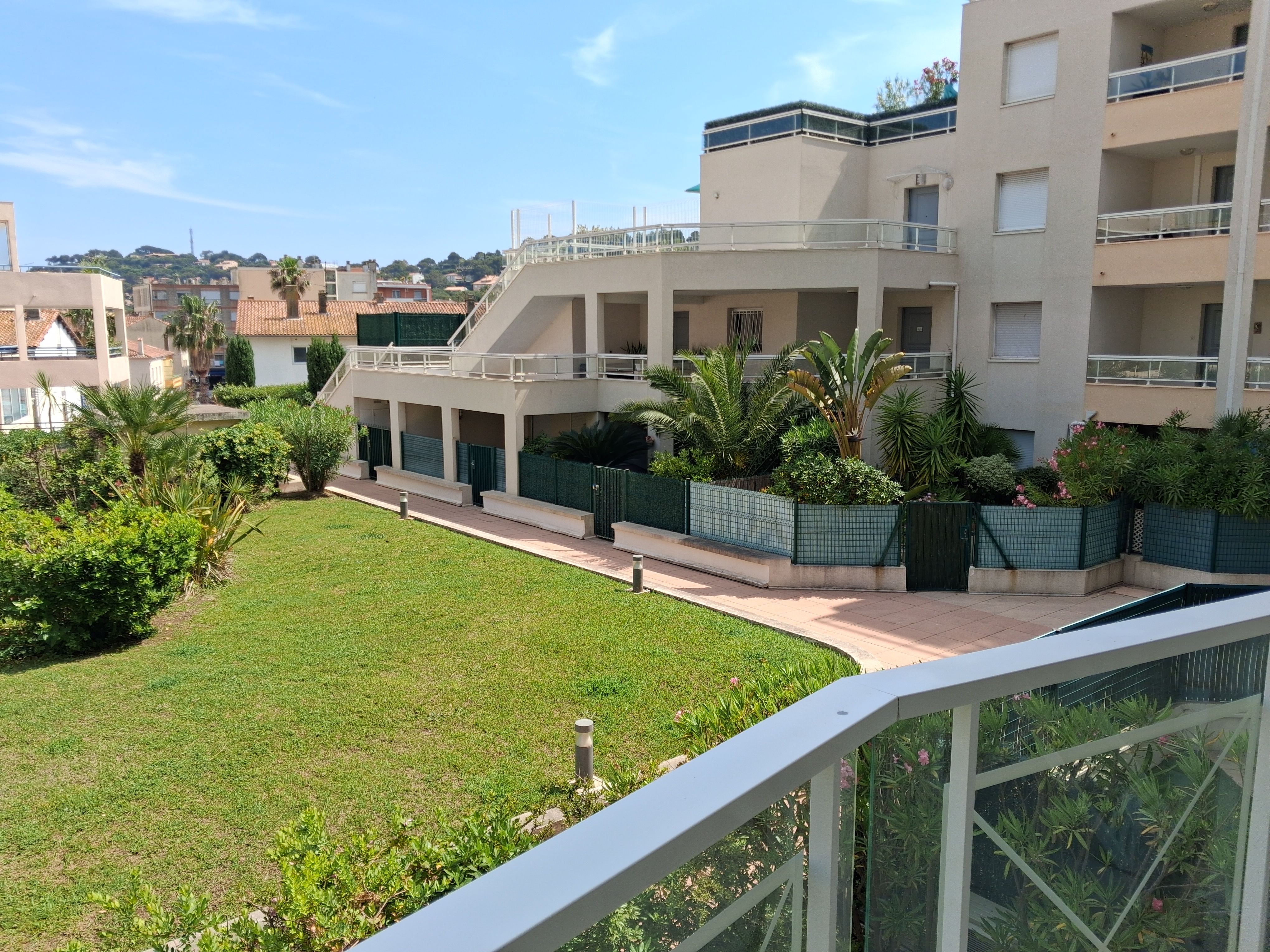 image Views of the palm-fringed grounds from the balcony, with the beach just a short walk down the road