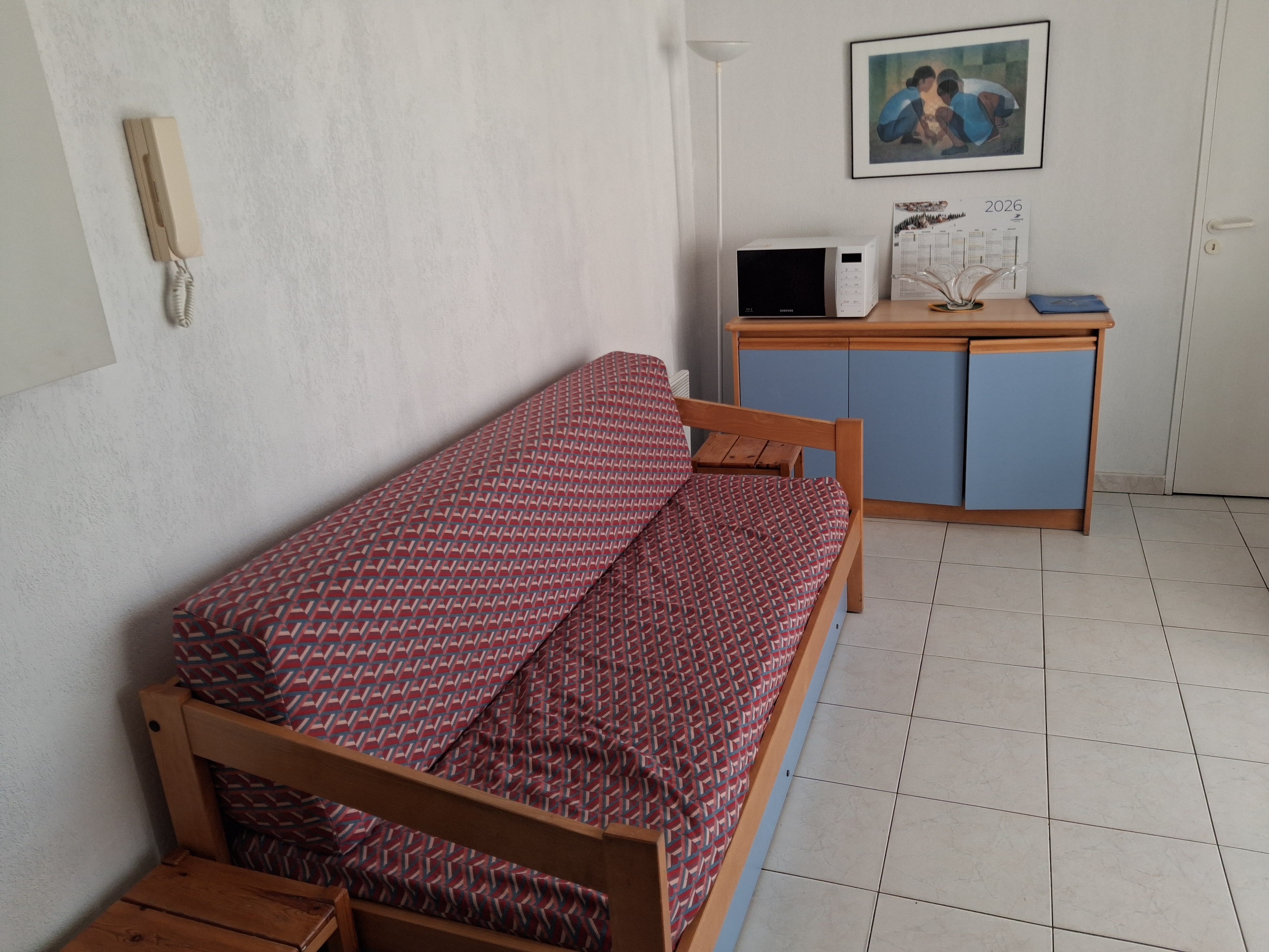 image Back from the beach, the living room has a sofa, dining area, and TV — everything you need to wind down