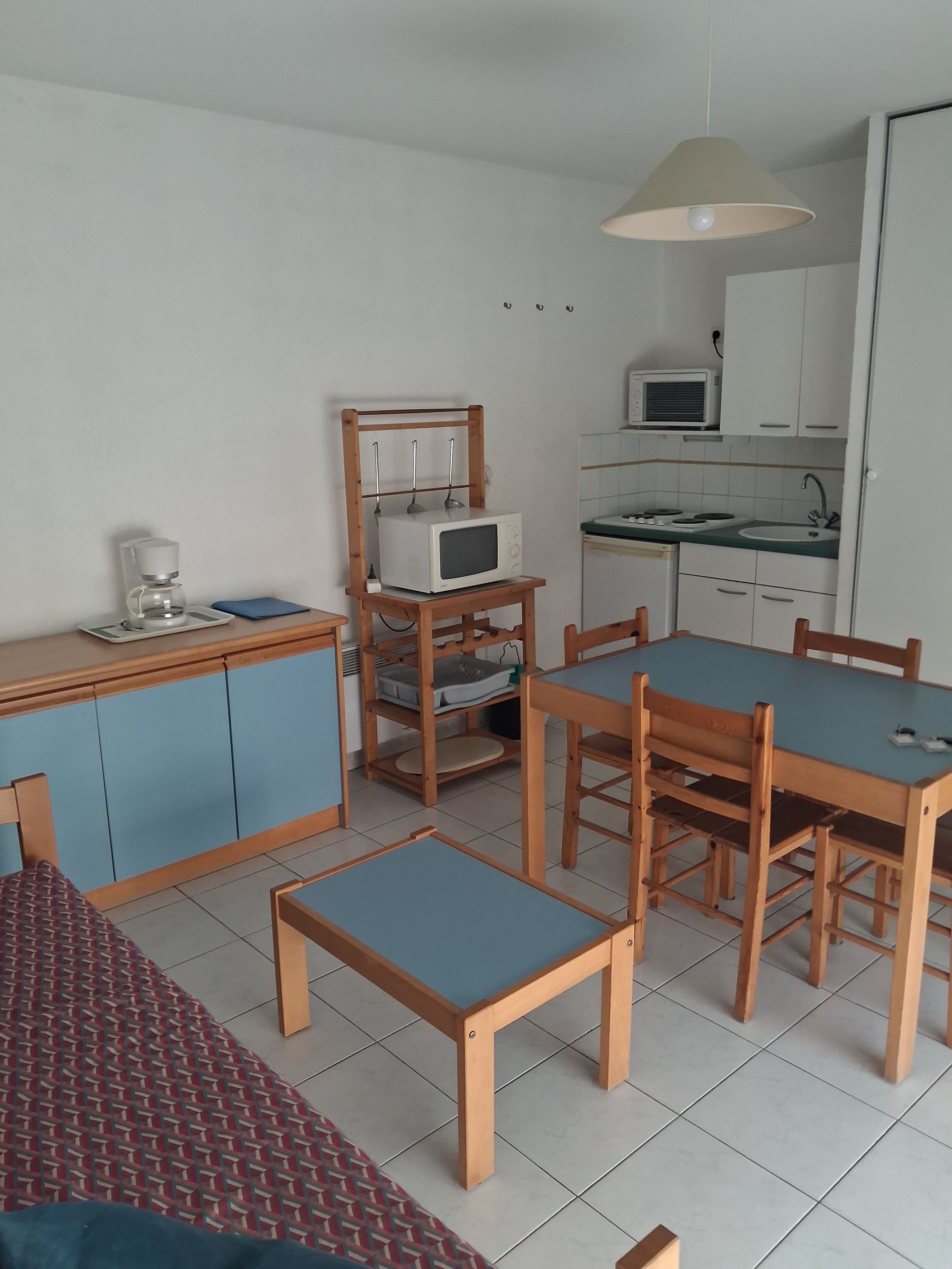 image Dining table, kitchenette, and sliding terrace doors all in one open-plan space — the layout works well for groups of six