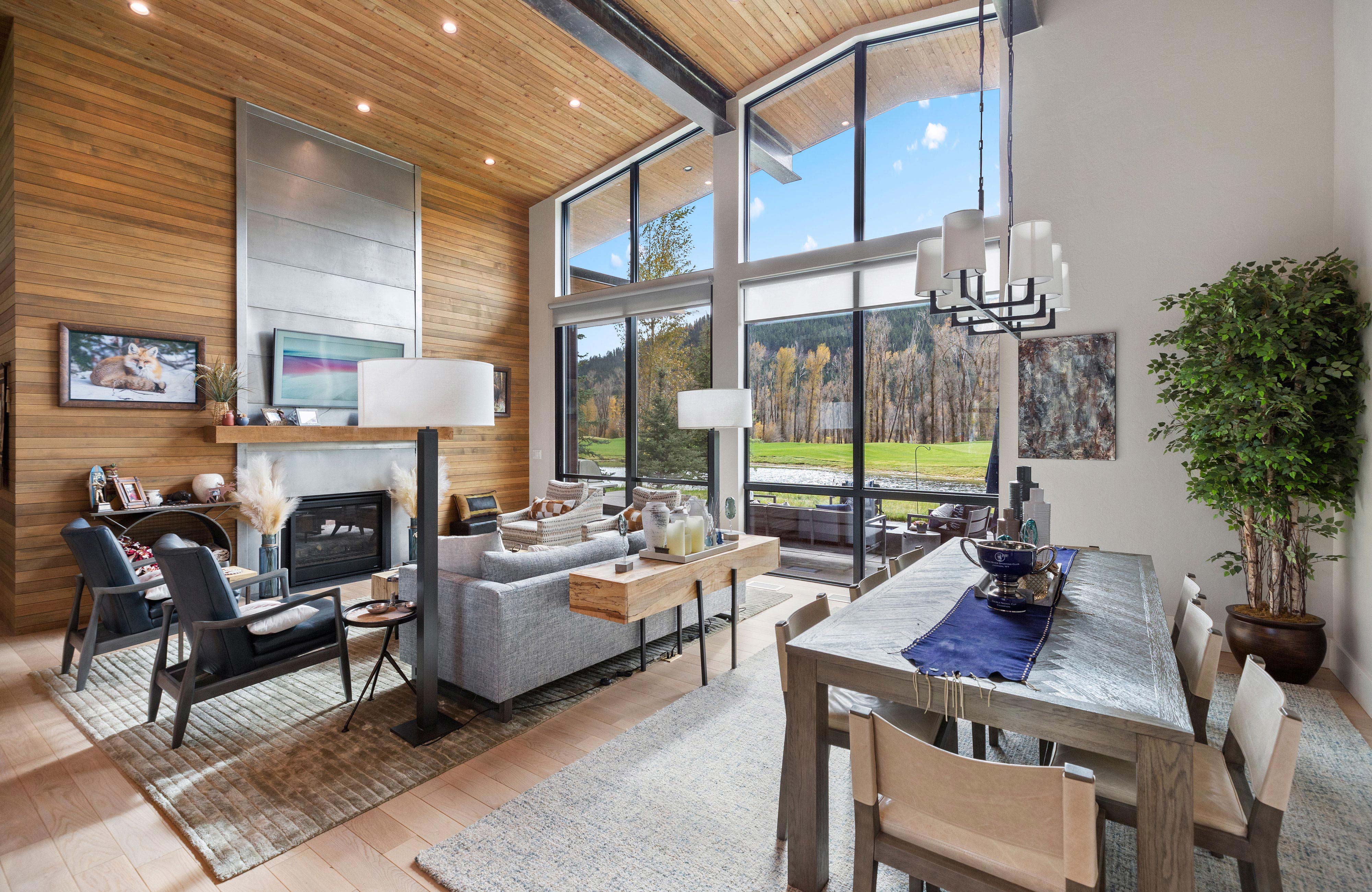 image Living area with natural light, artwork, and floor-to-ceiling windows facing the Wyoming landscape
