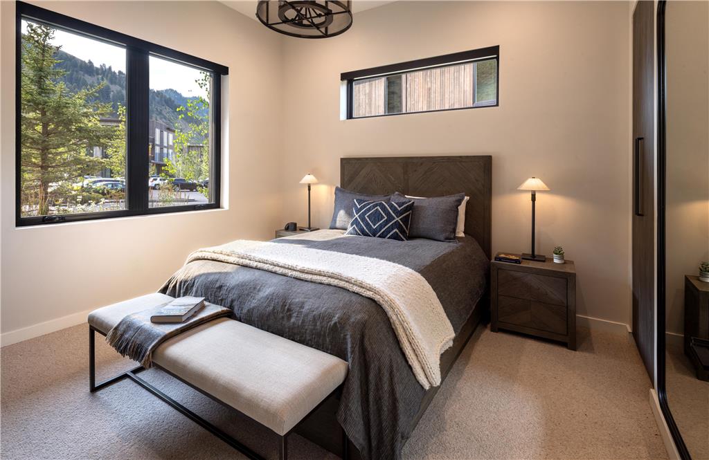 image Modern bedroom with large windows and mountain views