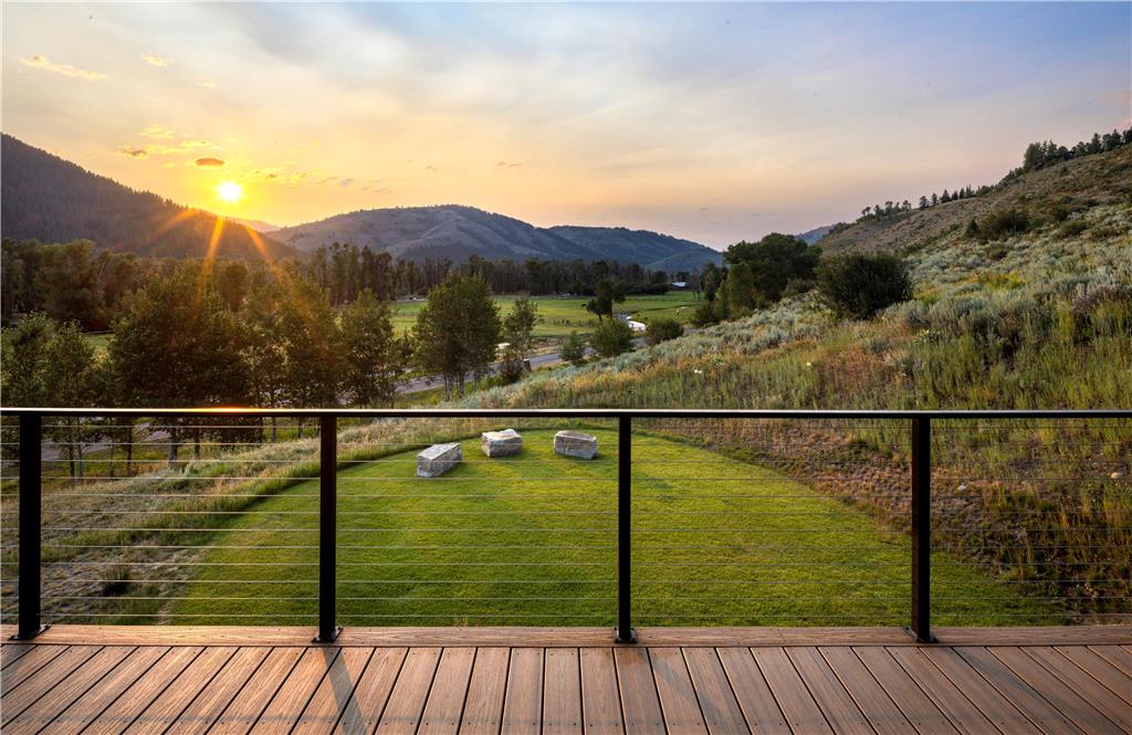 image Wooden deck with rolling hills and mountain views at dusk