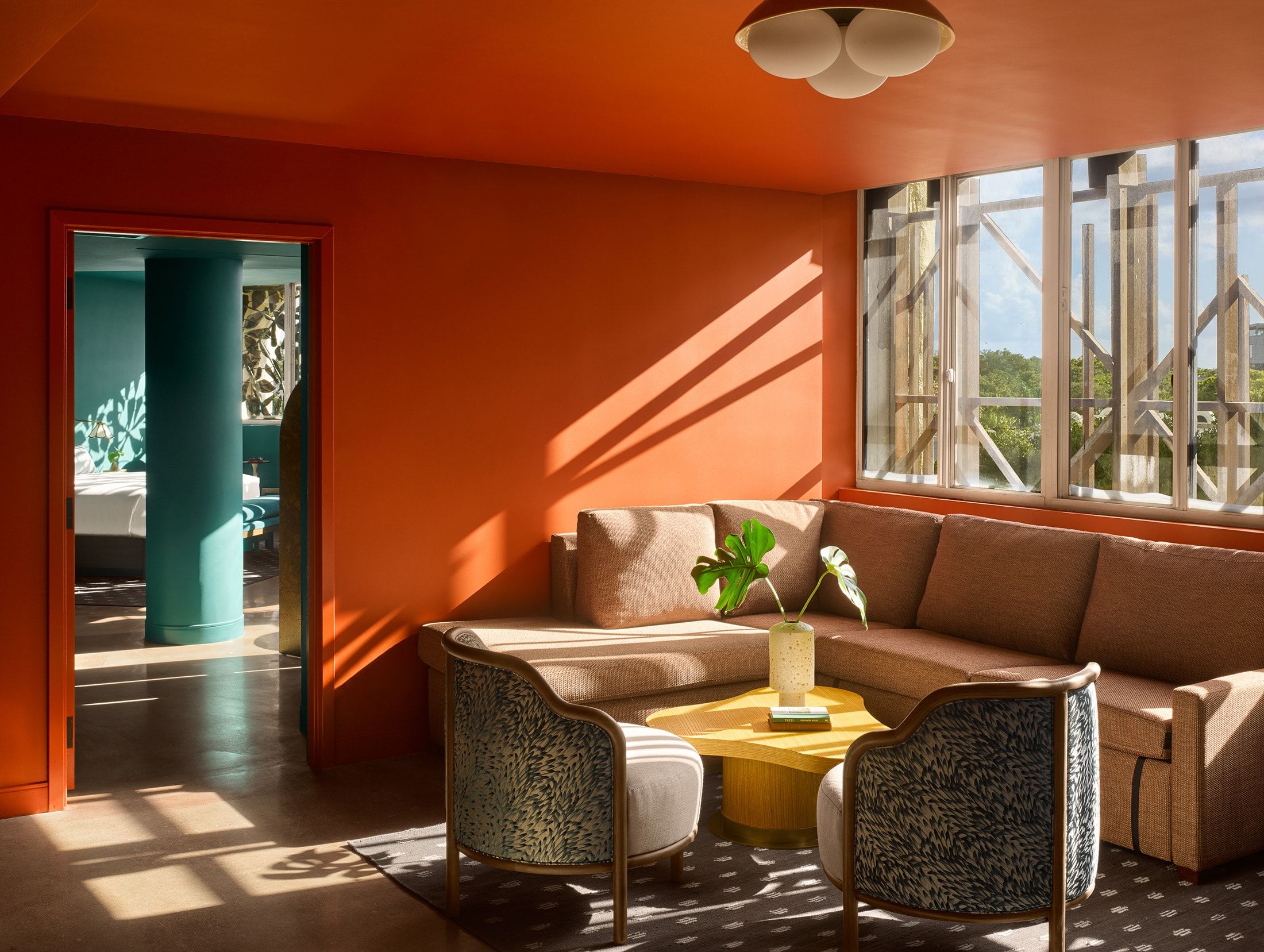 image Lounge area with bright patterned furniture and afternoon sunlight through the windows