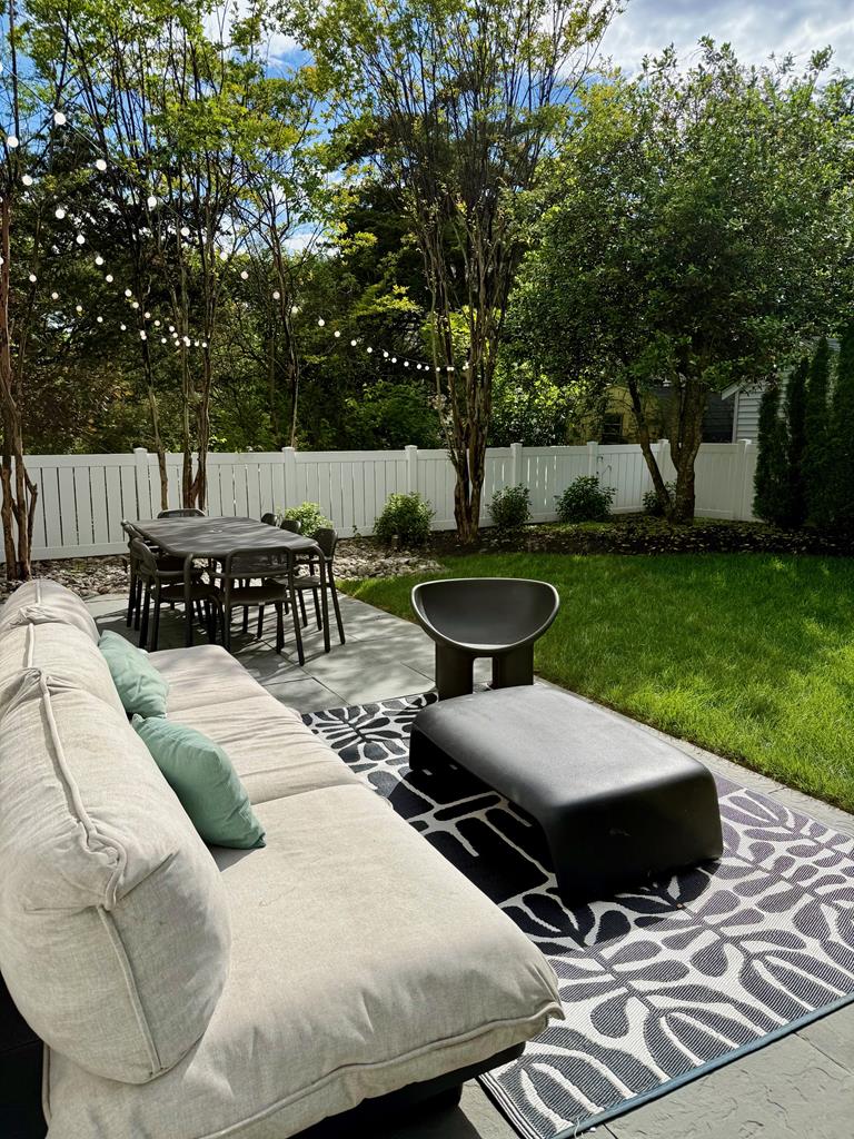 image Relax on comfortable seating surrounded by greenery, perfect for sun-soaked afternoons and evening gatherings.
