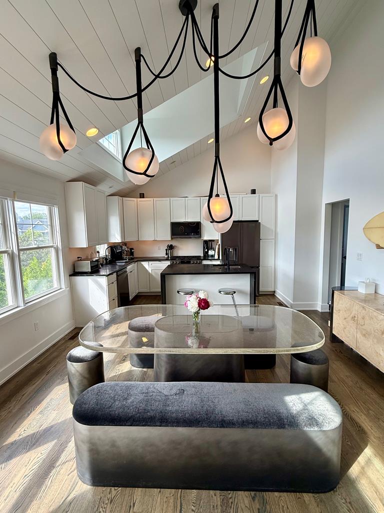 image Gather around the unique dining area, where modern design meets cozy comfort under elegant lighting.