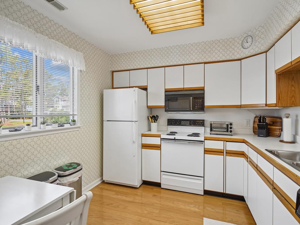 image Enjoy a fully stocked kitchen with natural light and seating for meals together