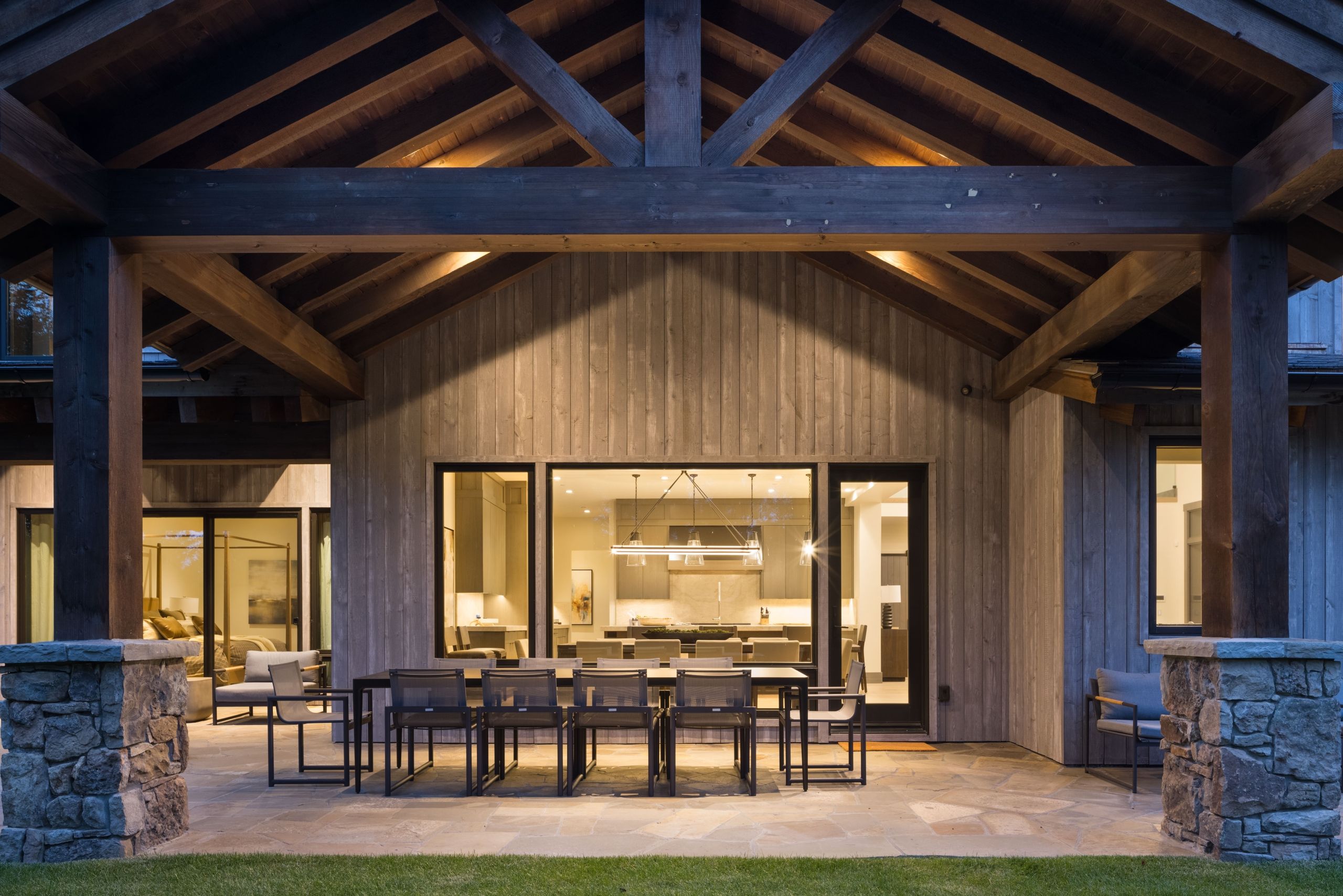 image Mountain pines surround the home's exterior on a clear summer day.