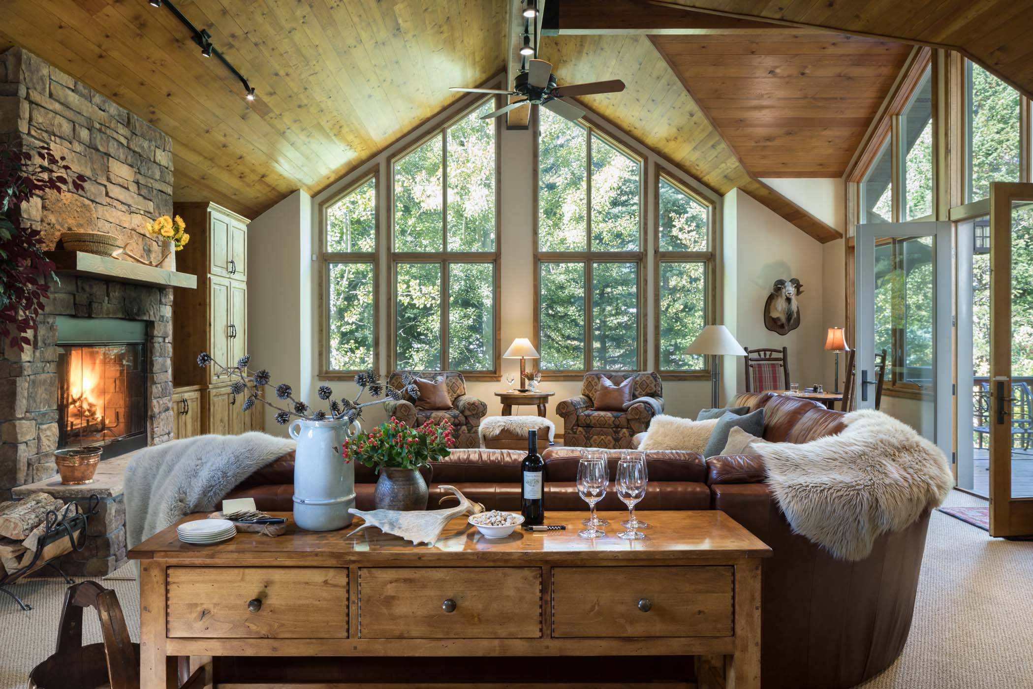 image Panoramic forest views frame the open-concept great room and kitchen.