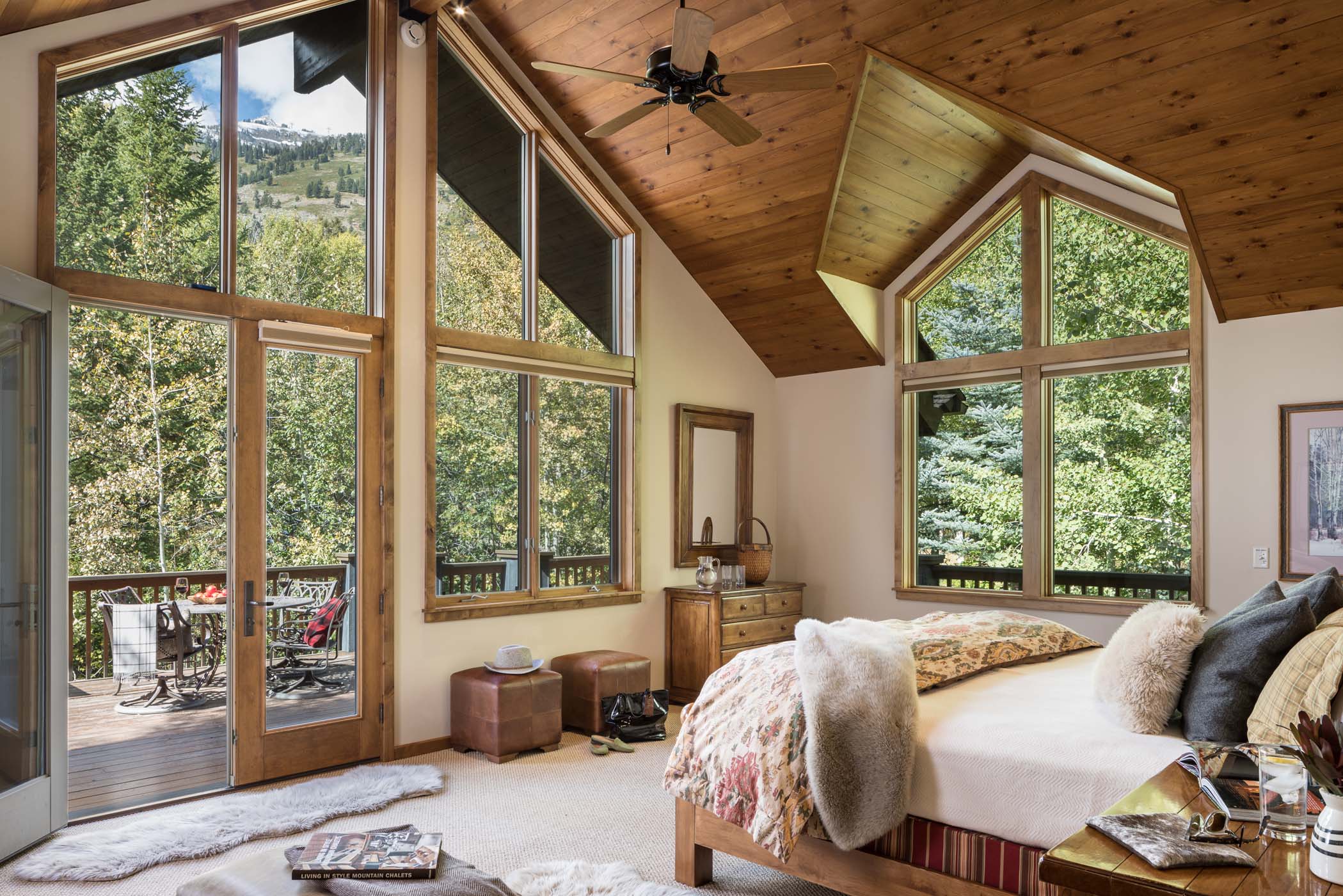 image King bed and vaulted ceilings define the primary suite's forest-view bedroom.