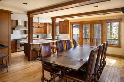 Professional-grade appliances equip the chef's kitchen beside the dining area.