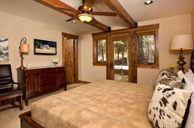 Beams cross the ceiling of this bedroom, which opens directly onto the outdoors.