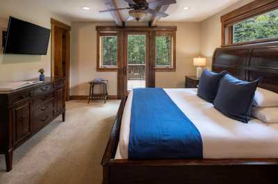 Beams cross the ceiling of this bedroom, which opens directly onto the outdoors.