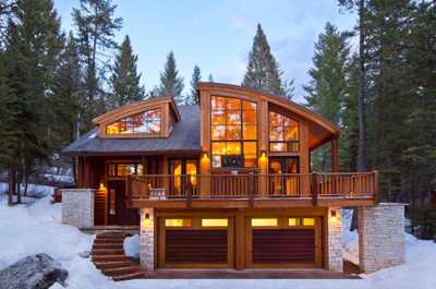 A wrap-around deck and double garage wrap the exterior of the three-floor lodge.