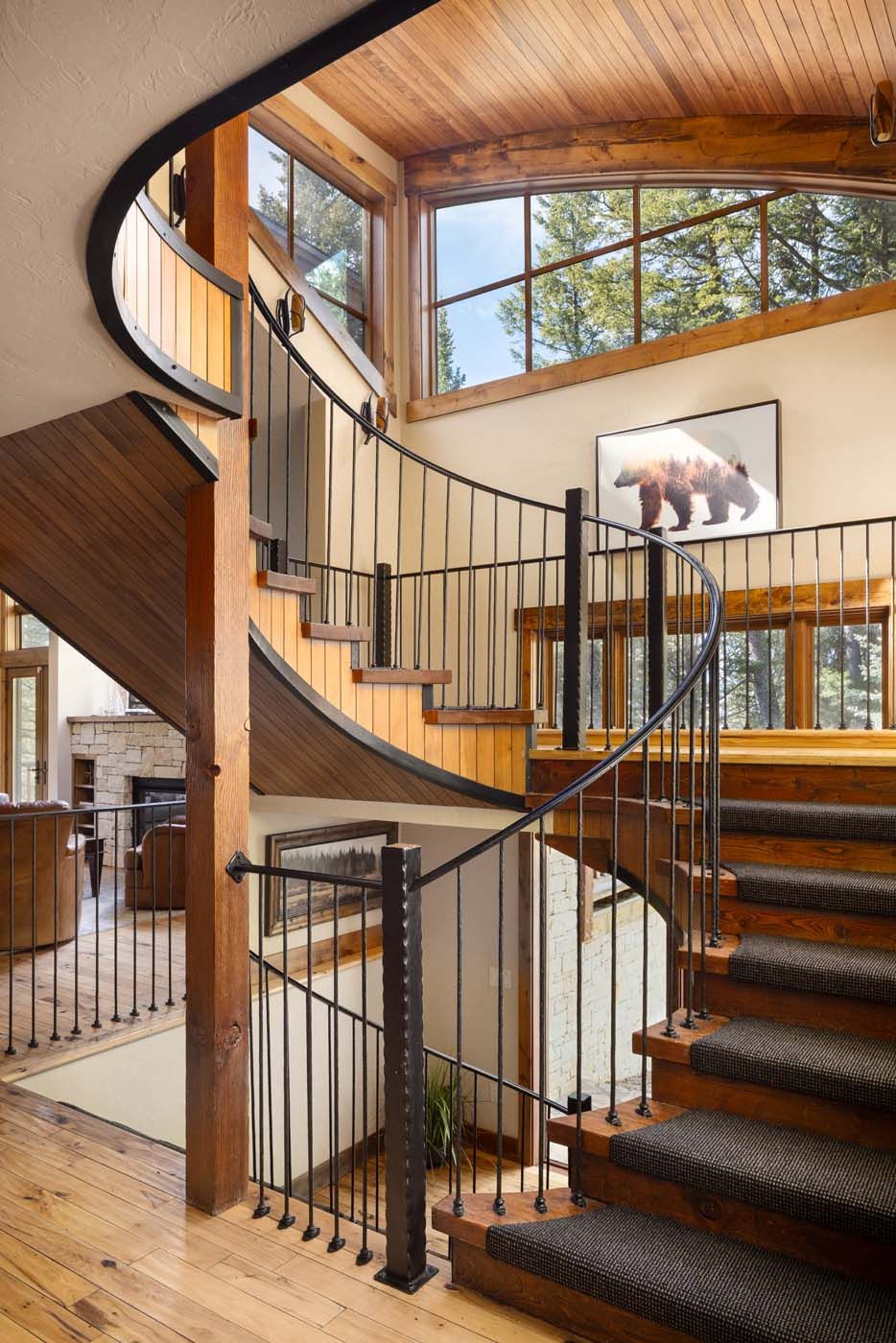 image Custom artwork lines the walls beside the signature spiral staircase.