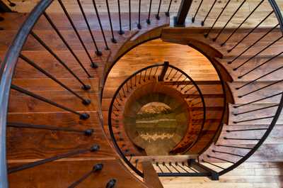 Overhead views reveal how the spiral staircase unites all three floors.