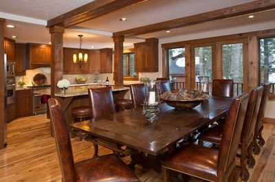 Gather around the wood dining table for meals from the chef's kitchen, equipped with professional-grade appliances.