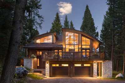 Warm light glows from every window of the lodge after dark.