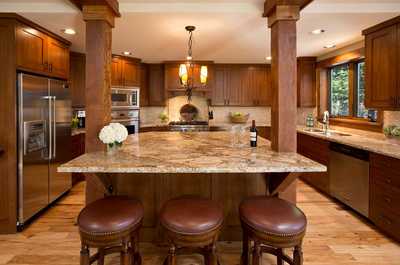 Prepare meals at the kitchen island, backed by wood cabinetry and full-size appliances.