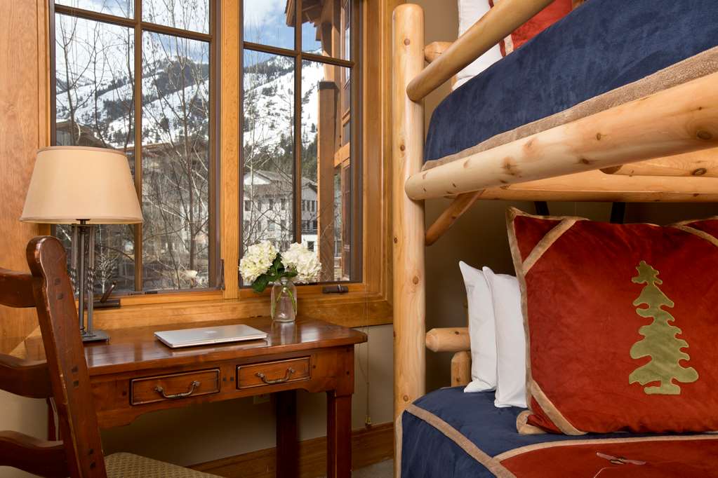 image Log bunk beds and a desk with mountain views.