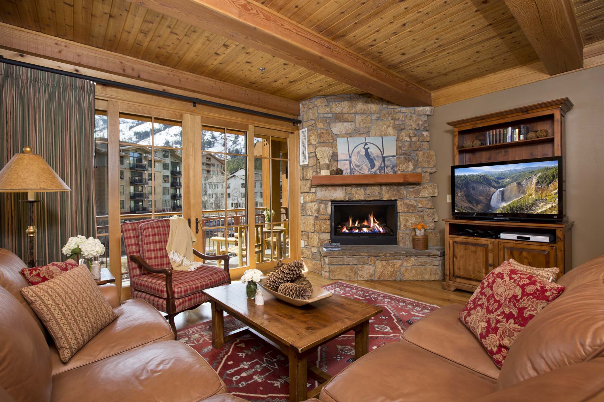 image A loveseat and couch face the gas fireplace in the open-plan living room.