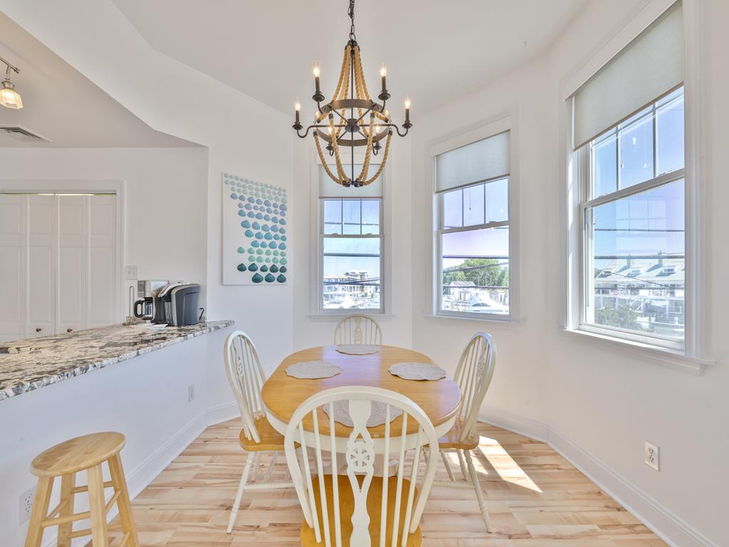 image Dining area with round table and chandelier by the windows