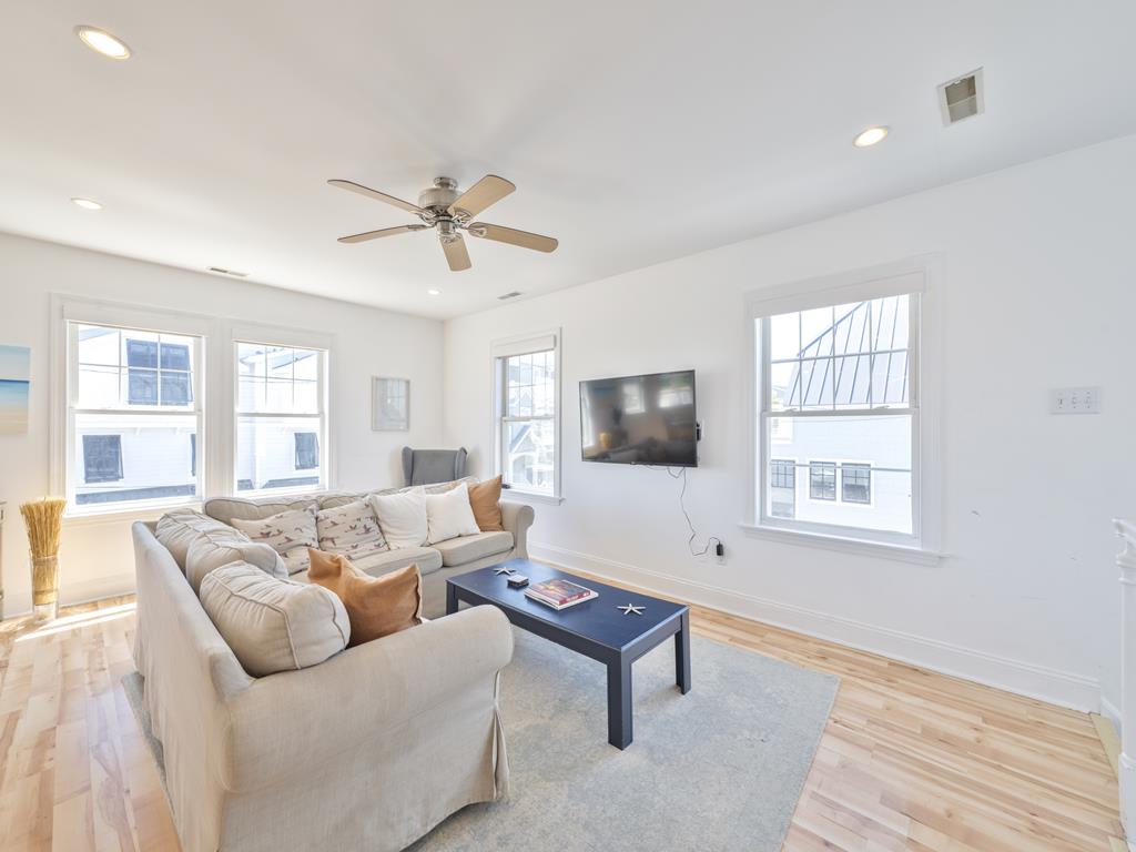 image Living room with sofa, TV and large windows