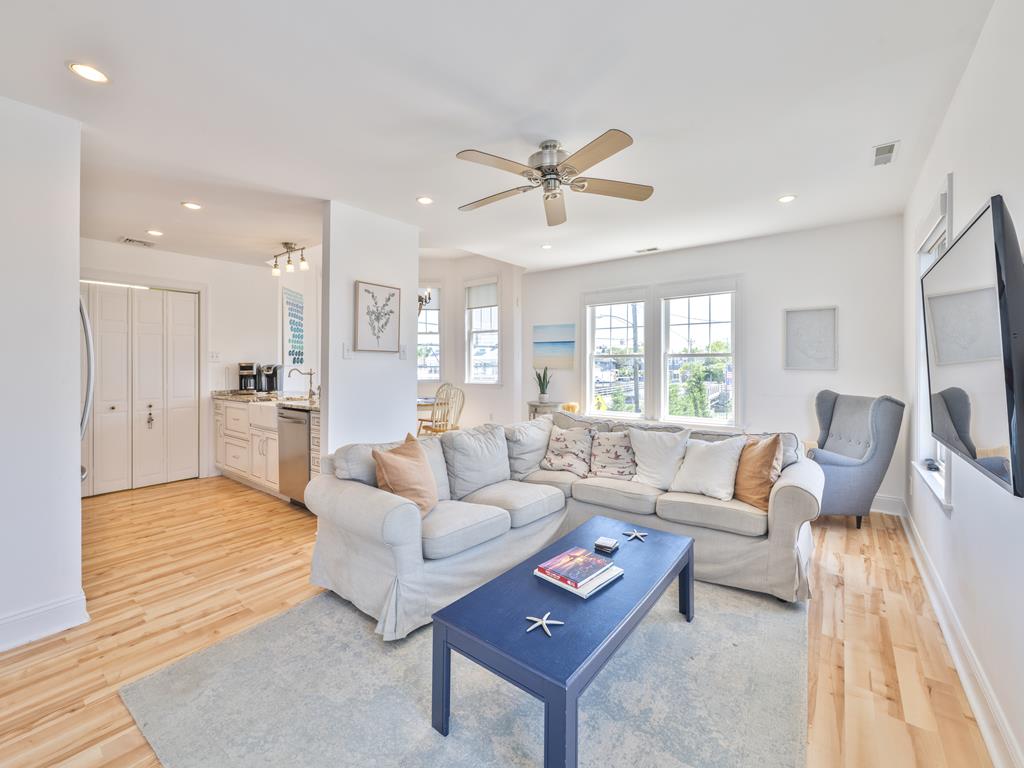 image Living room with sofa, coffee table and ceiling fan