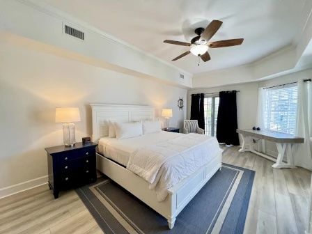 image King bedroom with ceiling fan and access to the private balcony